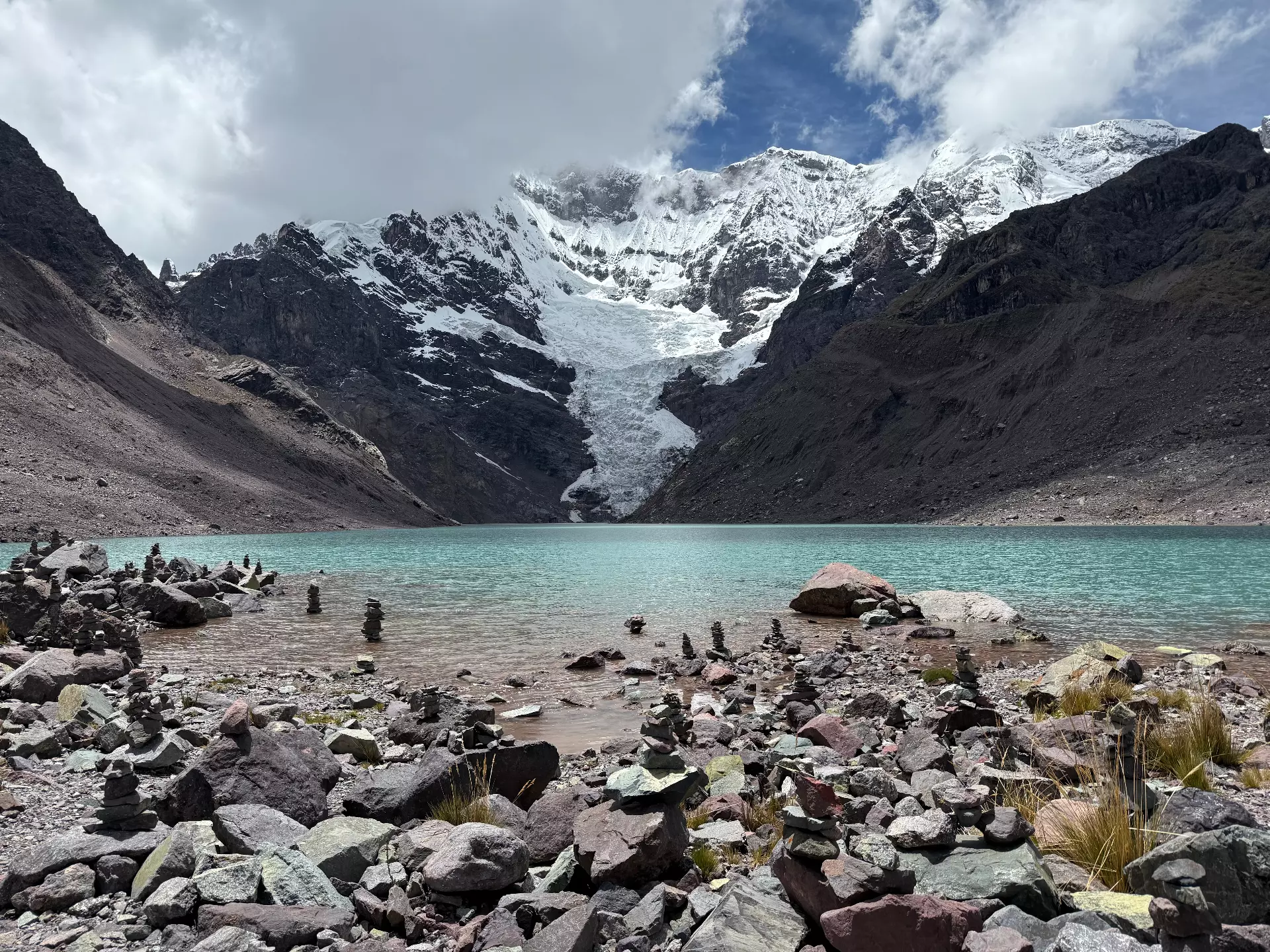 Sacred Ausangate Mountain and turquoise lake in the Peruvian Andes
